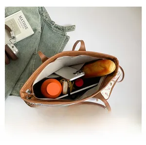 Top view of large floral tote bag interior showing capacity with phone and water bottle