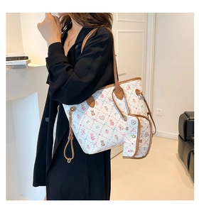 Détail du sac cabas à imprimé ours avec pochette assortie sur la poignée en cuir marron