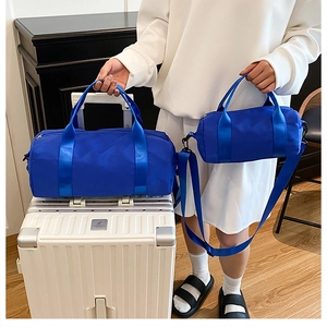 Blue cylindrical fitness bags in two sizes featuring shiny nylon and detachable straps