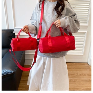 Red nylon duffle bags in large and small sizes with detachable shoulder straps
