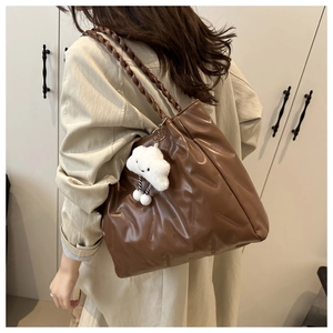 Brown tote bag with textured faux leather, woven strap and plush cloud charm detail