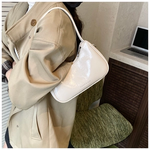 Detail of minimalist beige faux leather shoulder bag with FASHION & BAGS printed text