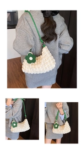 Détail du sac à texture bulles blanche avec bandoulière verte et pendentif fleur de mode