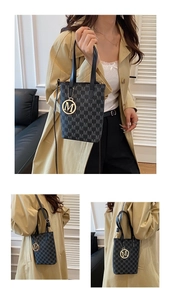 Detail view of the vintage monogram pattern and gold metal M charm on the handbag