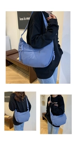 Detail of blue nylon crescent bag showing the textured fabric and woven rope zipper pull