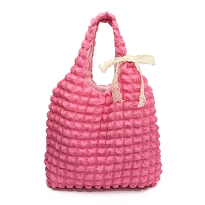 Pink popcorn texture puffer tote bag with a cream lace bow detail on handle