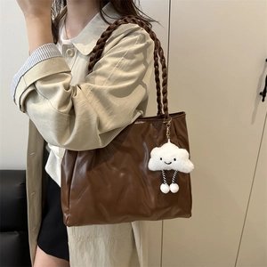 Brown textured PU leather tote bag with cloud charm shown on shoulder for casual daily use