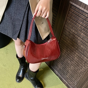 Deep red patent leather underarm bag with white logo lettering for casual style