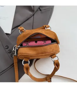 Internal view of brown suede crossbody bag showing capacity with a long wallet
