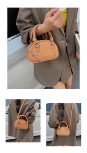 Detail of camel suede mini Boston bag with rivets and cylindrical dual handles