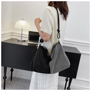Detail of high-capacity rhinestone hobo bag with black and white contrast design