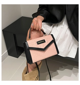 Detail of pink woven texture handbag with black leather trim and Fashion Bag logo