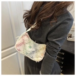Detail of Y2K style shoulder bag featuring rainbow gradient stars and frayed edges
