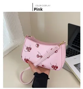 Detailed view of pink cherry print PU leather shoulder bag with slim strap and sleek finish