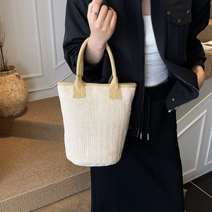 Minimalist cream woven bucket bag with elegant V-pattern and top handles for women