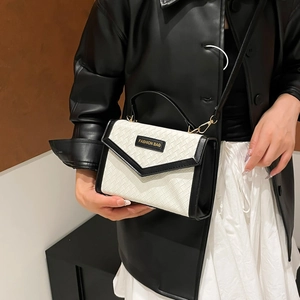 Minimalist woven texture handbag with black and white leather contrast and top handle