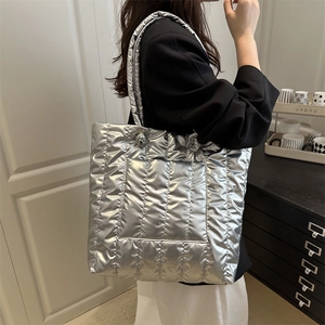 Silver metallic quilted down tote bag with a spacious interior for stylish daily commuting