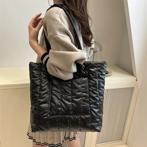 Black quilted puffer tote bag with large capacity and vertical stitching design