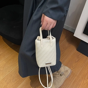 White woven crossbody phone bag with fine herringbone texture and metal plaque detail