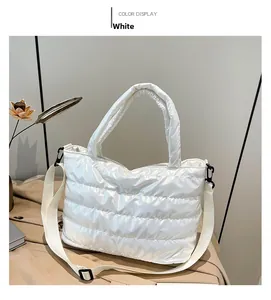 Macro shot of white quilted padded tote bag with glossy finish and adjustable strap
