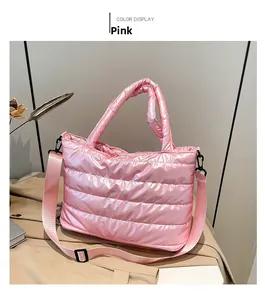 Detailed shot of pink quilted puffer tote bag featuring glossy finish and padded handles