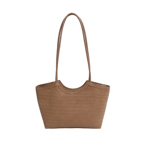 Brown woven tote bag with herringbone texture and long handles for stylish commuting