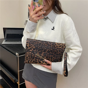Leopard print envelope clutch bag with gold metal trim and matching wrist strap