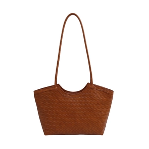 Brown woven tote bag with long shoulder straps shown on a clean white background