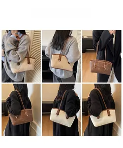 Detail of vintage canvas tote bag with leather trim and metal clasp in lifestyle setting