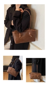 Detail view of brown vintage tote bag with knotted handles and fashion branding