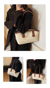 Detail view of cream and brown tote bag with leather texture and metal buckle accents