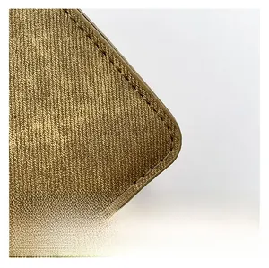 Macro shot of high-density twill fabric texture and precise brown stitching on bag corner