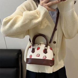 Chic strawberry print shell bag with brown handles and adjustable strap for women