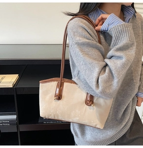 Detail of the knots and leather handles on this minimalist beige underarm shoulder bag