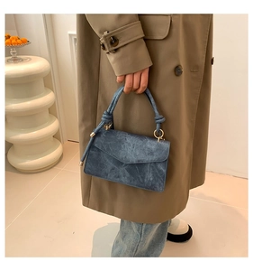 Blue vintage textured small square handbag styled with a khaki trench coat for daily wear