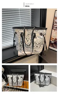 Grande borsa tote bianca con stampe graffiti nere e sottili tracolle alla moda