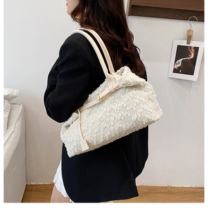 Detail shot of white wool blend tote bag showing textured fabric and leather straps