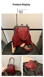 Detailed macro view of a vintage wine red leather shell bag with classic metal clasp closure
