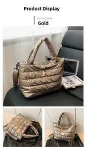 Close-up of golden quilted puffer tote bag featuring durable nylon fabric and handles
