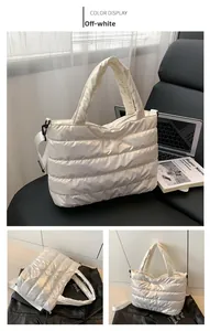 Detail of off-white quilted space cotton tote bag with glossy finish and shoulder strap