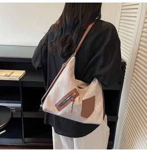 Close-up of minimalist canvas tote with premium leather strap and zipper detail
