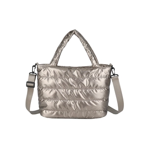 Chic metallic quilted tote bag with padded handles and adjustable crossbody strap