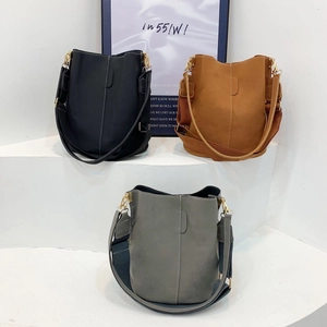 Minimalist matte bucket bags in black, brown, and grey with adjustable wide straps
