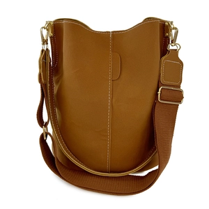 Brown bucket shoulder bag with white contrast stitching and adjustable wide canvas strap