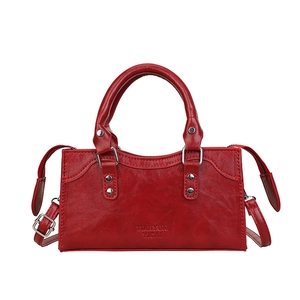 Elegant red faux leather mini handbag with top handles and adjustable shoulder strap