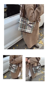 Detail of green plaid crossbody bucket bag with leather strap in autumn setting