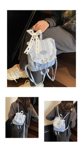 Close-up of blue and white plaid canvas backpack with lace bow and drawstring closure