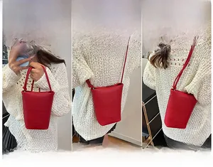 Red pebbled leather bucket bag shown in three styles: handbag, crossbody, and shoulder bag