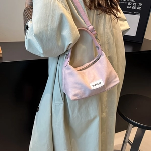 Pink denim dumpling bag with adjustable strap and MddJ37 patch for casual wear