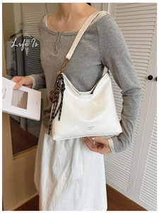 White faux leather shoulder bag with gold hardware and polka dot scarf detail